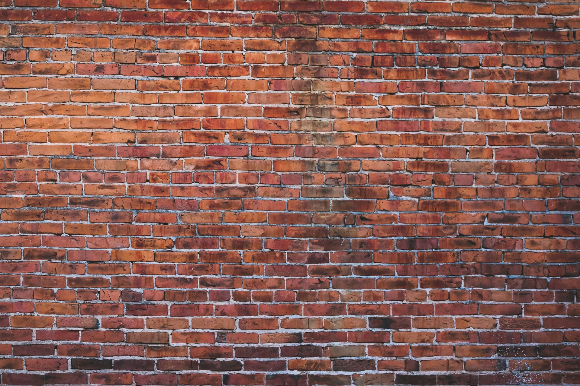 a red brick wall with a white fire hydrant